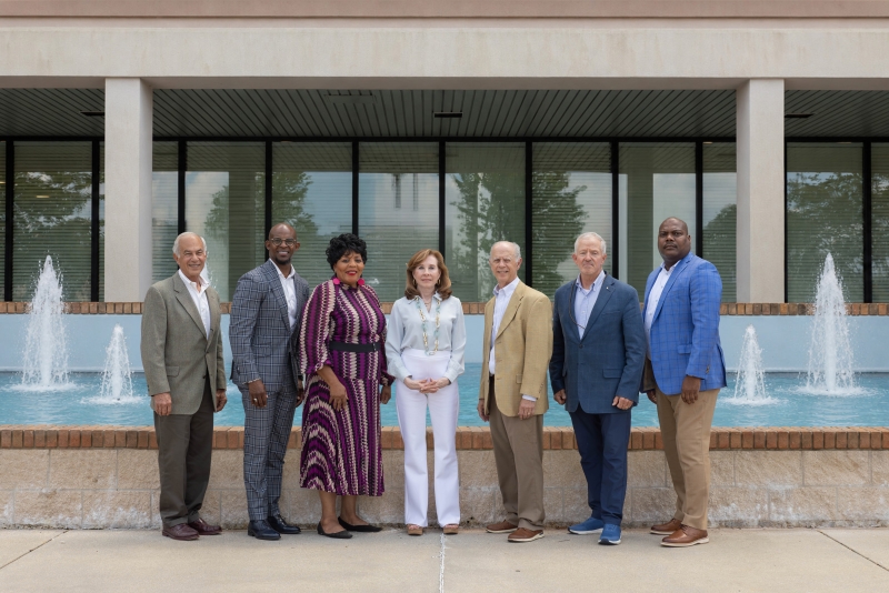The MAWSS Board of Commissioners pose in front of a fountain.