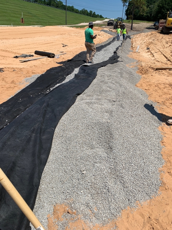 Installation of pipe drain from the toe berm as well as the building of the filter drain.